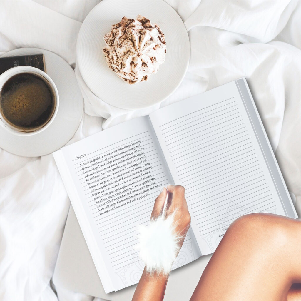 Female writing in her gratitude journal with her morning cup of coffee.